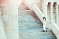 Woman bride in white wedding dress, fashion. Sensual woman on staircase. Girl with glamour look. Fashion model with long Royalty Free Stock Photo