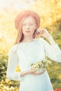 Woman bride in white wedding dress. Sensual woman in wreath on long blond hair. Albino girl with camomile daisy flowers Royalty Free Stock Photo