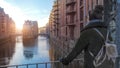 Woman on Bridge across channel in old warehouse district in Hamburg