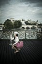 Woman in the bridge of arts in paris Royalty Free Stock Photo