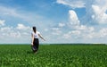 Woman with a briefcase walking on grass Royalty Free Stock Photo