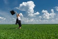 Woman with a briefcase walking on grass Royalty Free Stock Photo