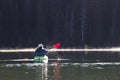 Woman In Bright Kayak On Lake