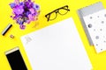 Woman bright yellow desktop with documents, accessories and flowers layout, copy space Royalty Free Stock Photo