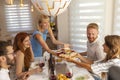 Woman bringing food to the table over Thanksgiving dinner Royalty Free Stock Photo