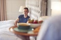 Woman Bringing Man Breakfast In Bed To Celebrate Wedding Anniversary Royalty Free Stock Photo