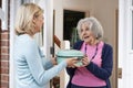 Woman Bringing Meal For Elderly Neighbour Royalty Free Stock Photo