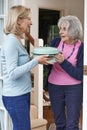 Woman Bringing Meal For Elderly Neighbour Royalty Free Stock Photo