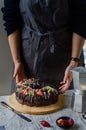 Woman brings strawberry cake to the table