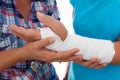 Woman with a broken arm and her caregiver Royalty Free Stock Photo