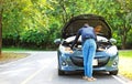 Awoman with a broken car and she open bonnet. Royalty Free Stock Photo