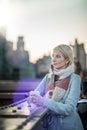 Woman on the Brooklyn Bridge Looking at Manhattan with a Coffee