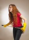 Woman with a broom styled rock guitarists (humorous photo)