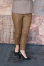 Woman in brown leather trousers