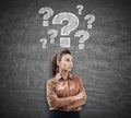 Woman in brown and question marks on blackboard Royalty Free Stock Photo