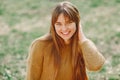 Elegant woman in a brown sweater in a spring park Royalty Free Stock Photo