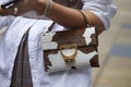 Woman with brown and white fur Coccinelle bag before Max Mara fashion show, Milan Fashion Week