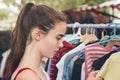 Woman browsing clothes on a flea market Royalty Free Stock Photo