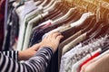 Woman browsing through clothing at second hand street market Royalty Free Stock Photo