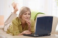 Woman browsing internet at home Royalty Free Stock Photo