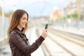 Woman browsing social media in a train station