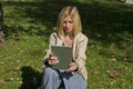 Woman browsing tablet in the park Royalty Free Stock Photo