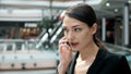 Woman brunette with phone smiling close up portrait. Young business woman professional happy. Beautiful multiethnic Royalty Free Stock Photo