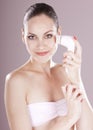 Woman with brush for deep cleansing facial.