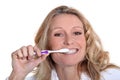 Woman is brushing her teeth