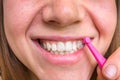 Woman brushing her teeth with interdental brush
