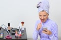 Woman brushing her teeth and talking on the phone