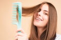 Woman brushing straight natural hair with comb. Girl combing long healthy hair with hairbrush. Hair care beauty concept Royalty Free Stock Photo
