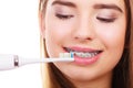 Woman brushing teeth with braces using brush Royalty Free Stock Photo