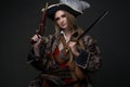 Woman buccaneer dressed in pirate suit and hat