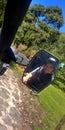 Woman on a buggy car on difficult terrain, dirt and mud, you can see the rear-view mirror and the road that leads to adventure