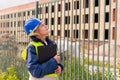 A woman Builder at a construction site inspects a house made of brick Royalty Free Stock Photo