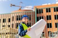 A woman Builder at a construction site inspects a house made of brick Royalty Free Stock Photo