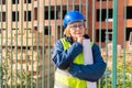 A woman Builder at a construction site inspects a house made of brick Royalty Free Stock Photo