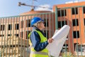 A woman Builder at a construction site inspects a house made of brick Royalty Free Stock Photo