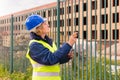 A woman Builder at a construction site inspects a house made of brick Royalty Free Stock Photo