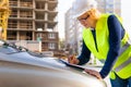 A woman Builder at a construction site inspects a house made of brick Royalty Free Stock Photo