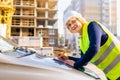 A woman Builder at a construction site inspects a house made of brick Royalty Free Stock Photo