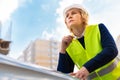 A woman Builder at a construction site inspects a house made of brick Royalty Free Stock Photo