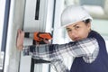 woman builder drilling wall in new house Royalty Free Stock Photo