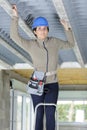 woman in builder hardhat looking at ceiling Royalty Free Stock Photo