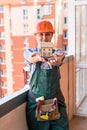 Woman in builder helmet holding house model and keys Royalty Free Stock Photo