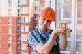 Woman in builder helmet holding house model and keys Royalty Free Stock Photo