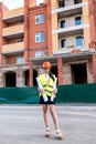 Woman in builder helmet and vest holding rolls of blueprints Royalty Free Stock Photo