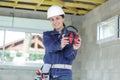 Woman builder holding ear protection Royalty Free Stock Photo