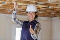 woman builder holding showing thumb up